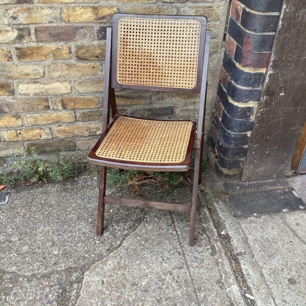Vintage rafia dining chair with wooden frame and woven seat.