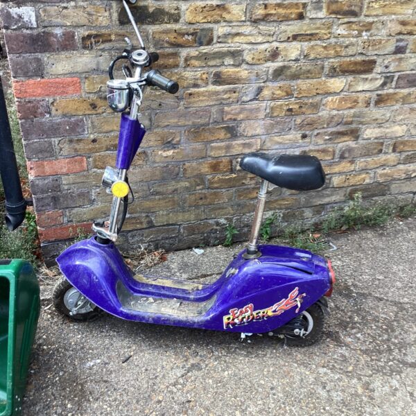 Purple electric scooter offered for spares or repair project.