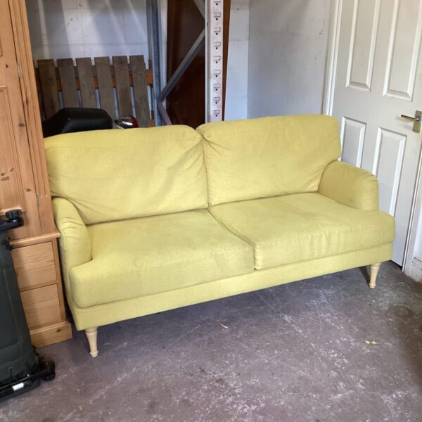 Mustard yellow two-seater sofa with tapered legs.