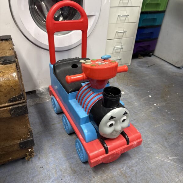 Bright blue Thomas the Tank Engine ride-on toy for toddlers.