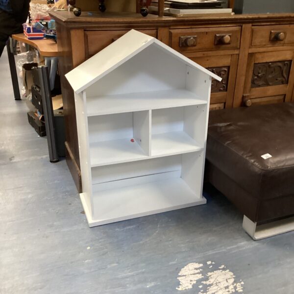 White painted childs bookcase with three shelves for storage.