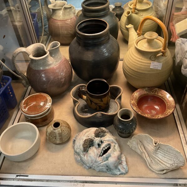 Mixed studio pottery collection featuring jugs, bowls, and vases.
