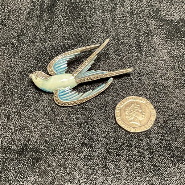 Vintage 1950s marcasite swallow brooch with blue enamel detail.