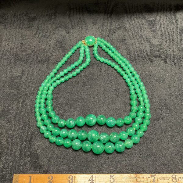Vintage jade green three-strand graduated bead necklace.