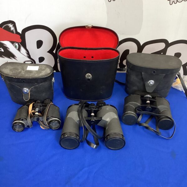 Lot of three vintage binoculars, including Pentax brand.