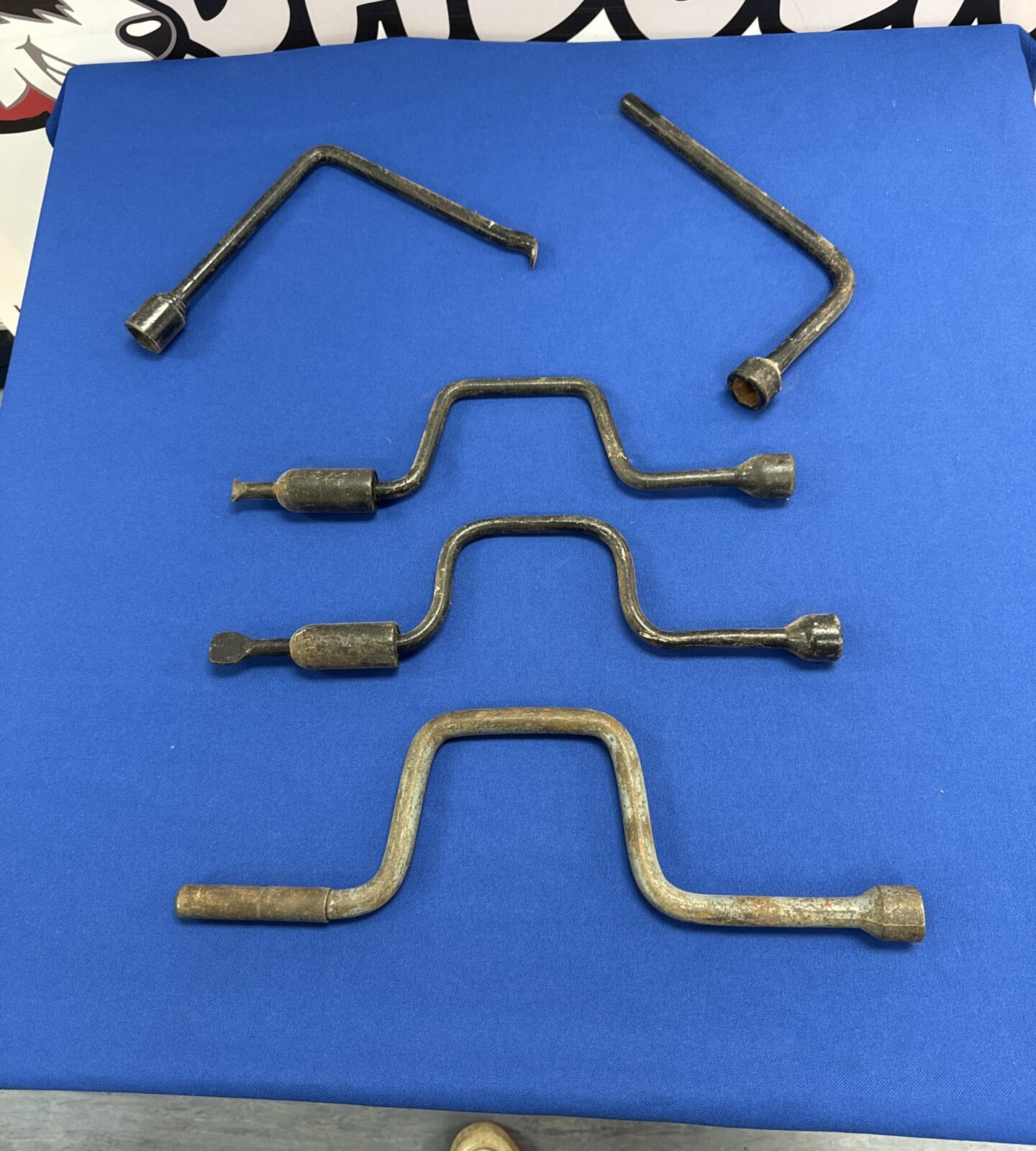 Five vintage wheel nut braces