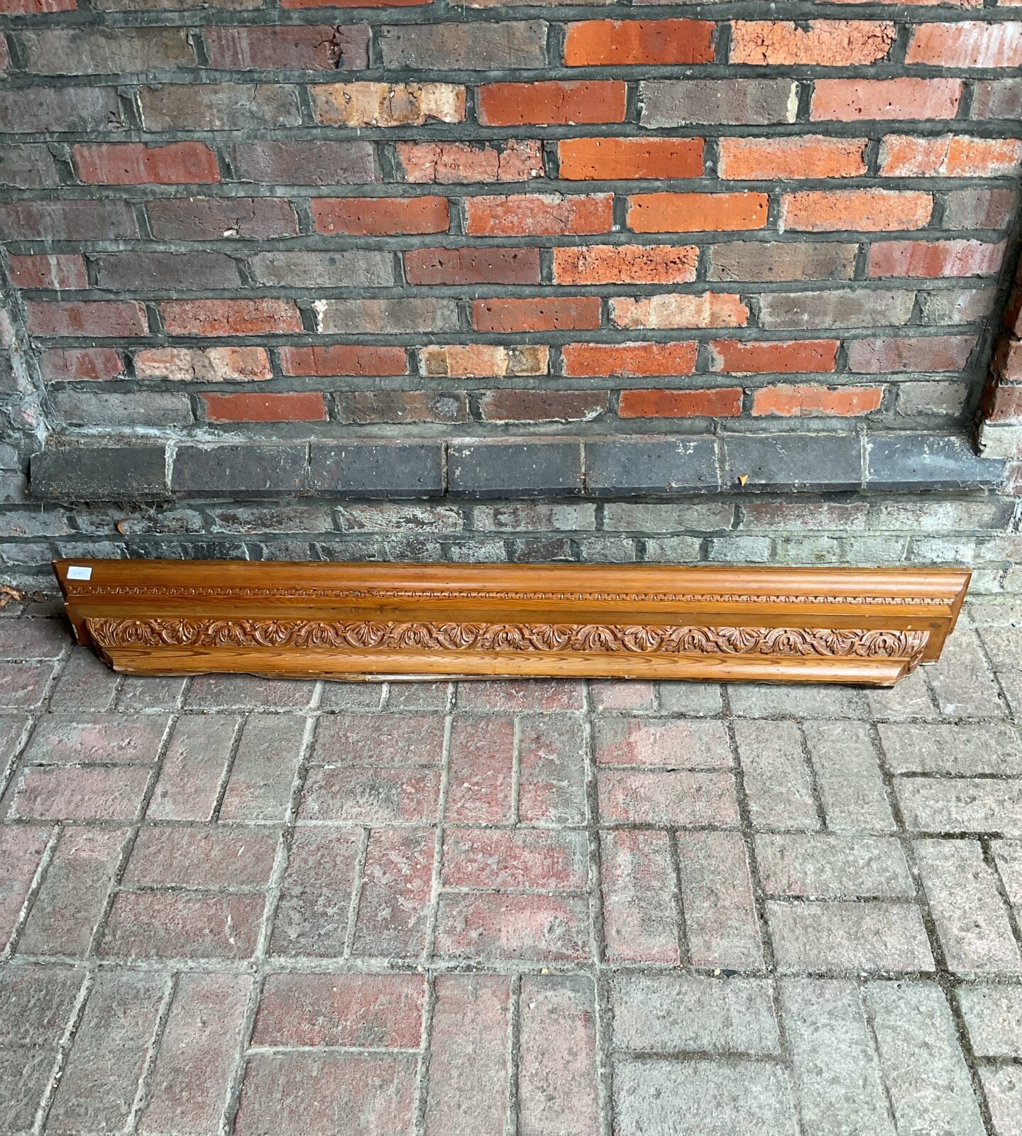 Antique pine mantle with carved leaf pattern design