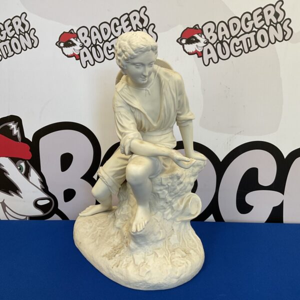 Parian ware figure of a young man sitting on stump