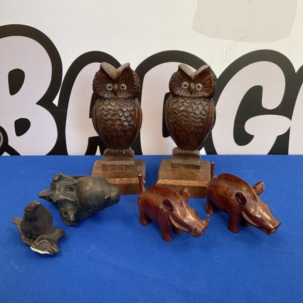 Vintage carved wooden owl and boar figurines, folk art collectibles.
