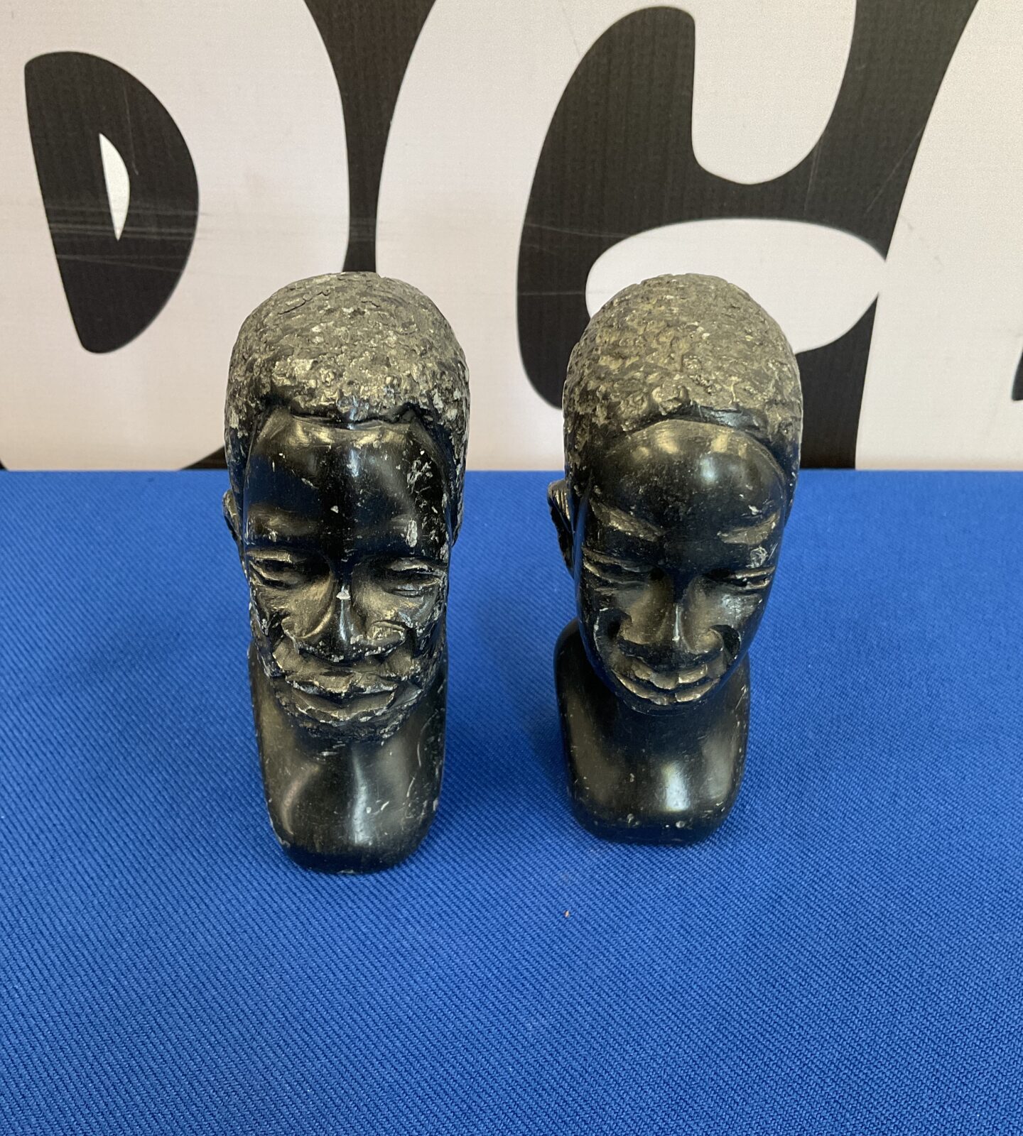 Pair of vintage carved stone busts of tribal elders