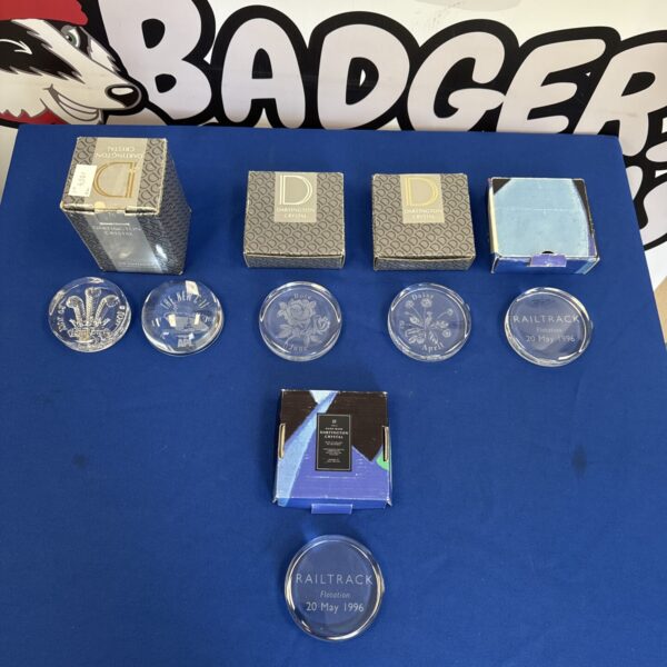 Selection of colourful Dartington Crystal paperweights in original boxes.