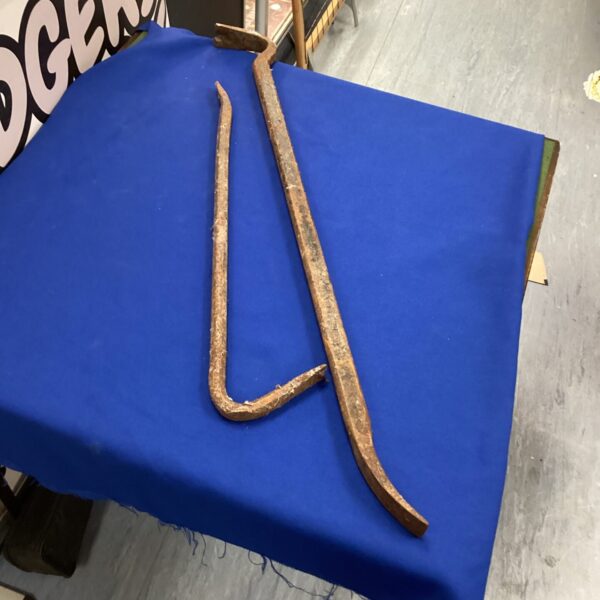 Pair of vintage steel crowbars for demolition and restoration.