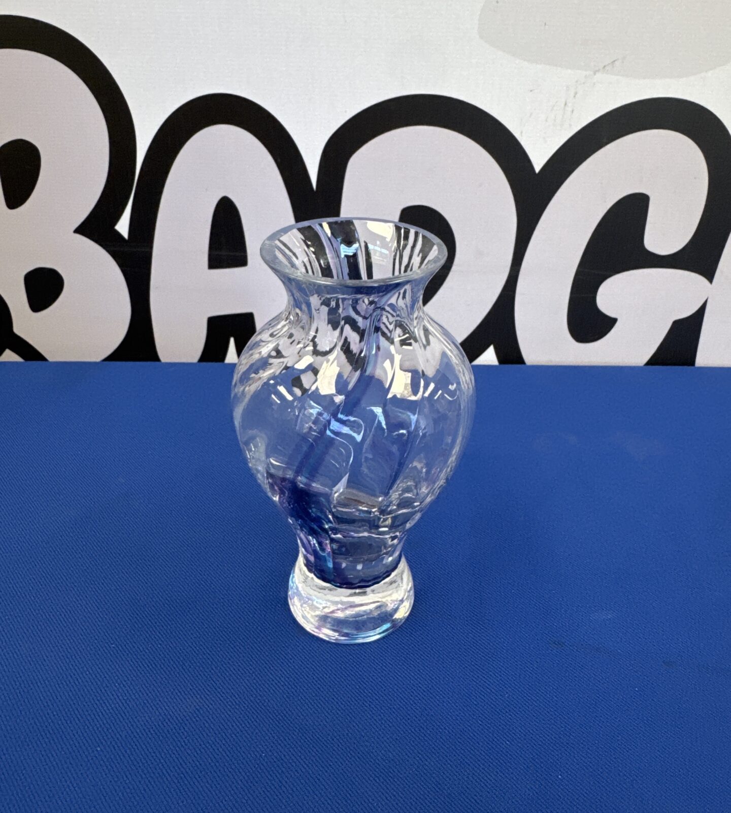 Small glass twist vase with violet colour streak