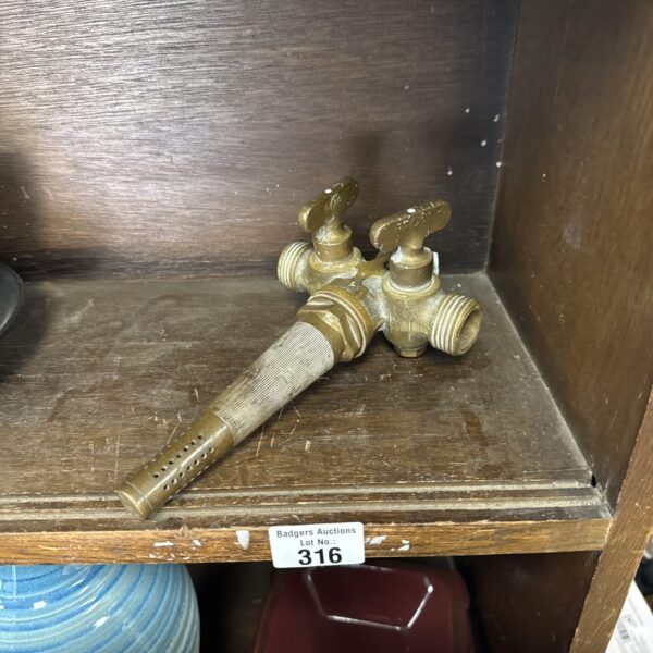 Vintage brass double beer tap with detailed craftsmanship.