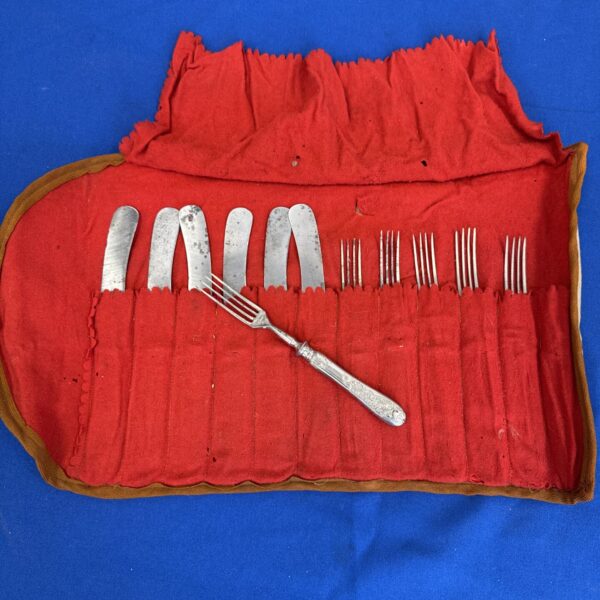 Antique German cutlery set displayed in a red felt roll.