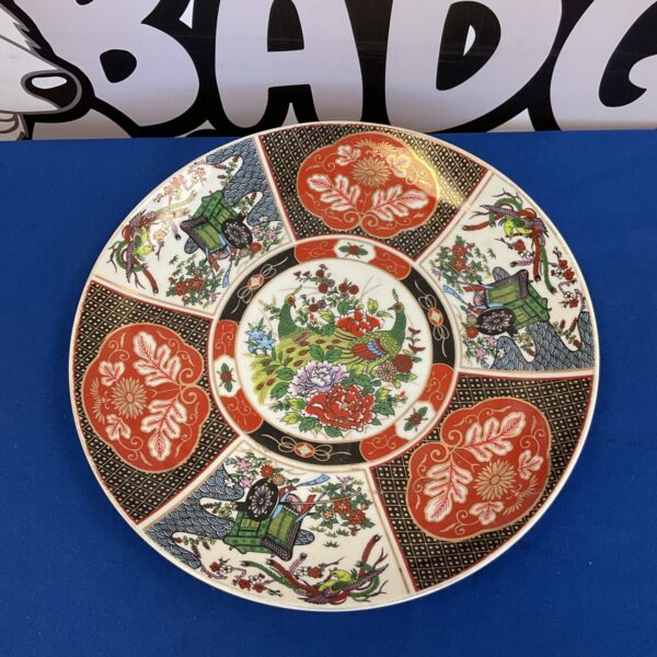 Antique Imari plate with vibrant floral and bird designs.