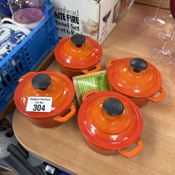 Set of four Robert Dyas miniature cast iron casserole pots.