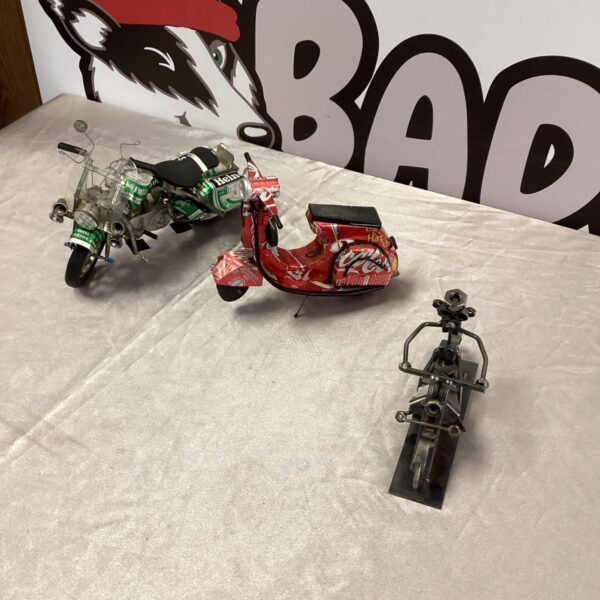 Group of three handmade motorcycles from recycled cans.