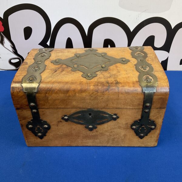 Small wooden treasure chest with brass banding, vintage style.