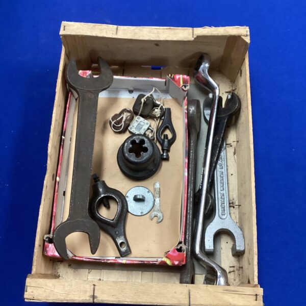 Vintage spanners and padlocks in a metal box, antique tool collection.