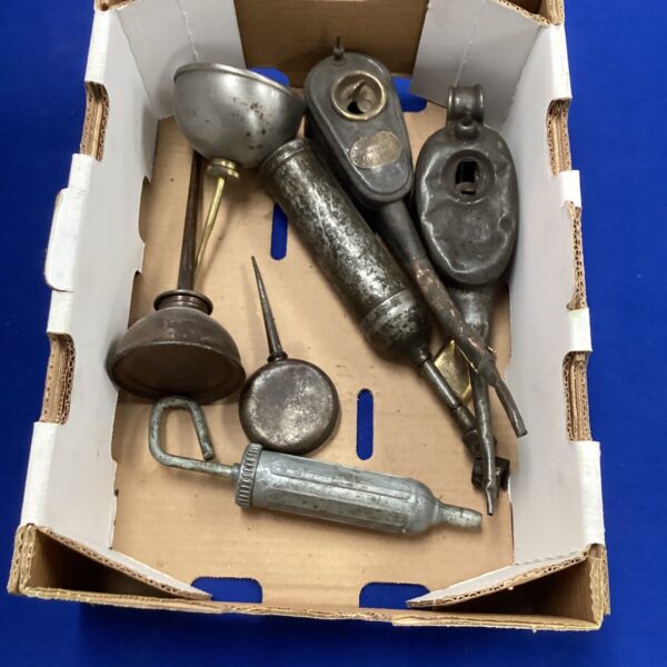 Vintage oil cans and grease guns in a lot for collectors.