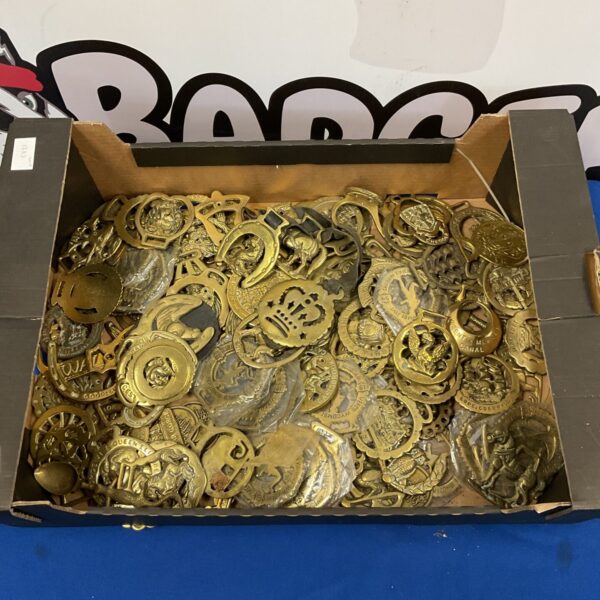 Large collection of antique horse brasses for collectors and decor.