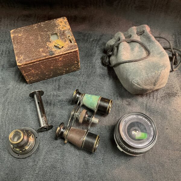 Vintage camera lot featuring Olympus lens, box camera, and binoculars.