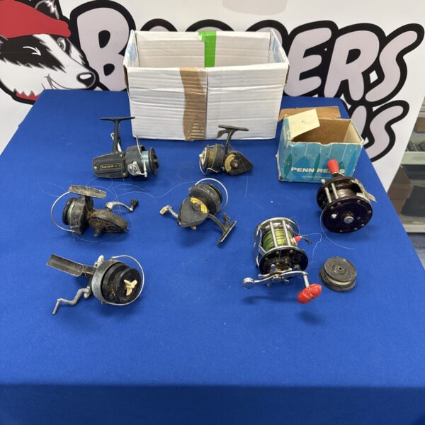 Vintage fishing reels including Intrepid and Daiwa models in a collection.