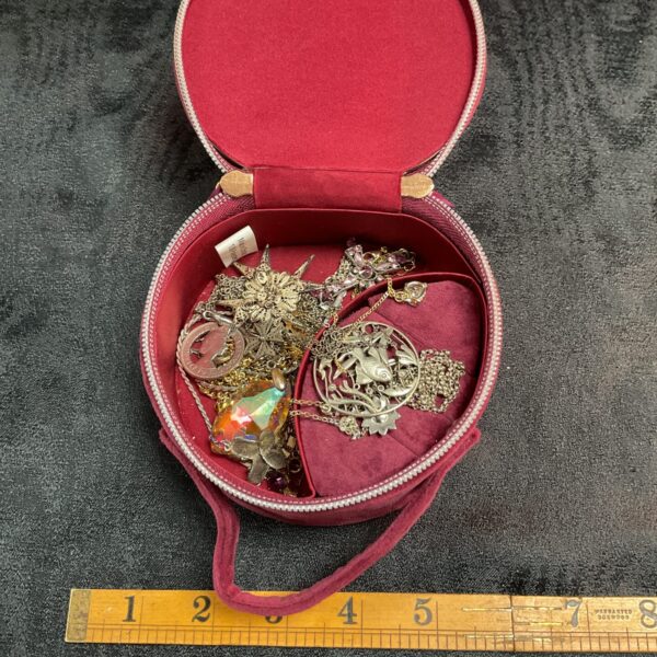 Vintage Ghost jewellery case open with silver jewellery inside.
