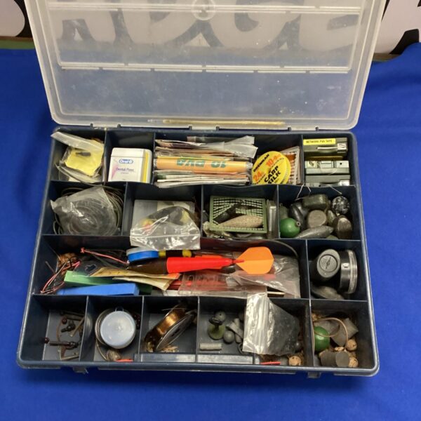 Open fishing tackle box with assorted lures and hooks.