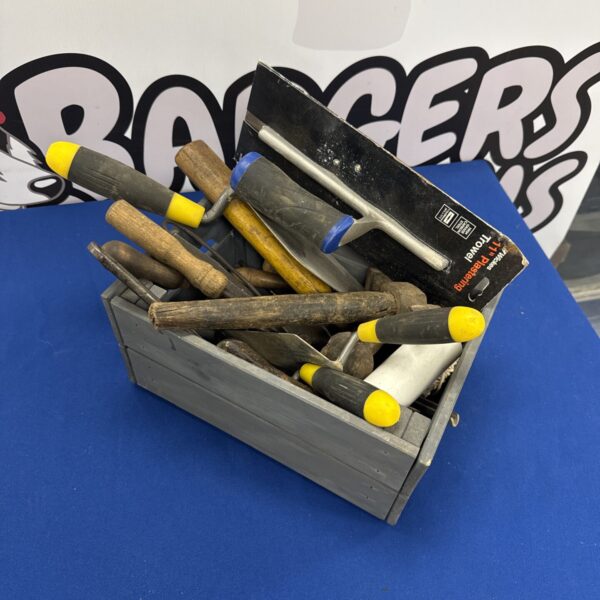 Vintage hand tool assortment in a wooden tray for DIY projects.