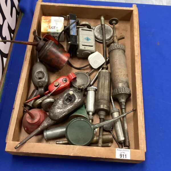 Vintage oil cans and tools lot for collectors and enthusiasts.