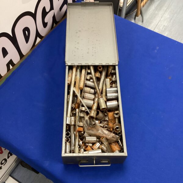Full view of vintage socket set inside metal toolbox.