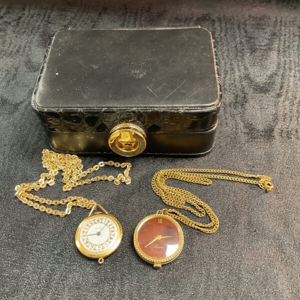 Vintage Lucerne and Westclox pendant watches with gold chains.