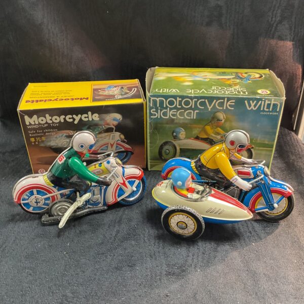Vintage tinplate clockwork motorcycles in original boxes.