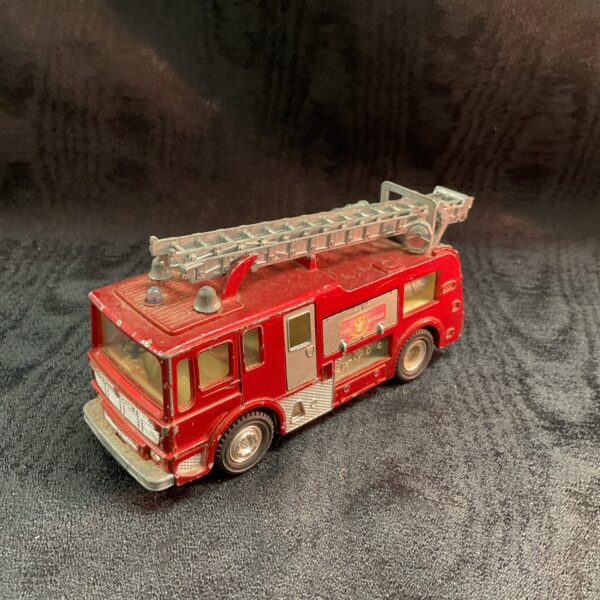 Side view of vintage Dinky Merryweather fire tender diecast toy.