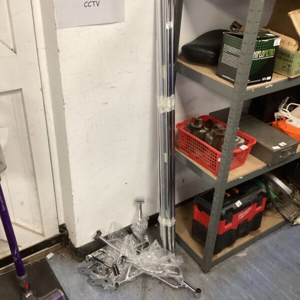 Stainless steel clothes rail system in used condition.
