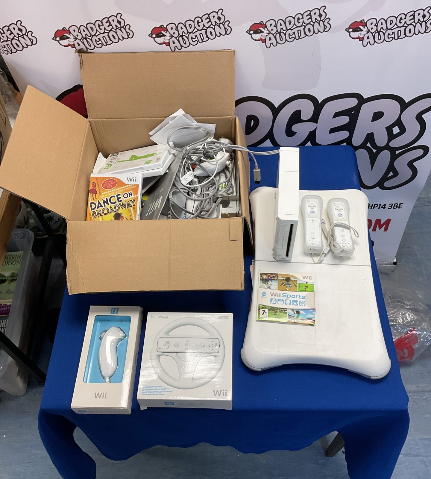 Nintendo wii console with two remotes, in box nunchucks, wii fit board and assorted games