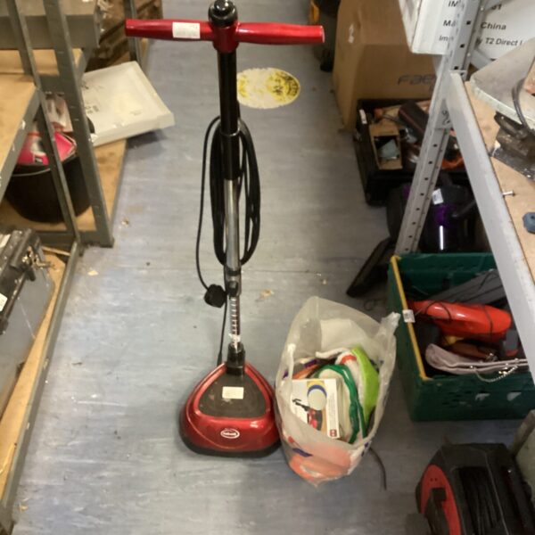 Vintage Ewbank floor cleaner with accessories on display.
