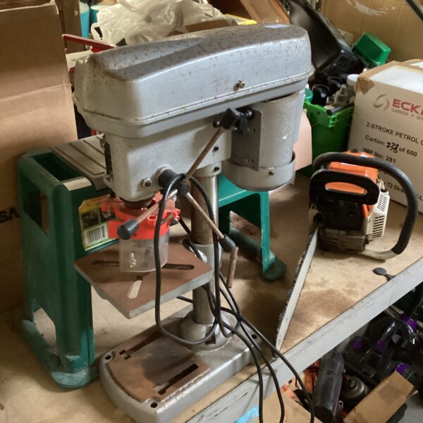 Vintage pillar drill in a workshop setting, ideal for restoration.