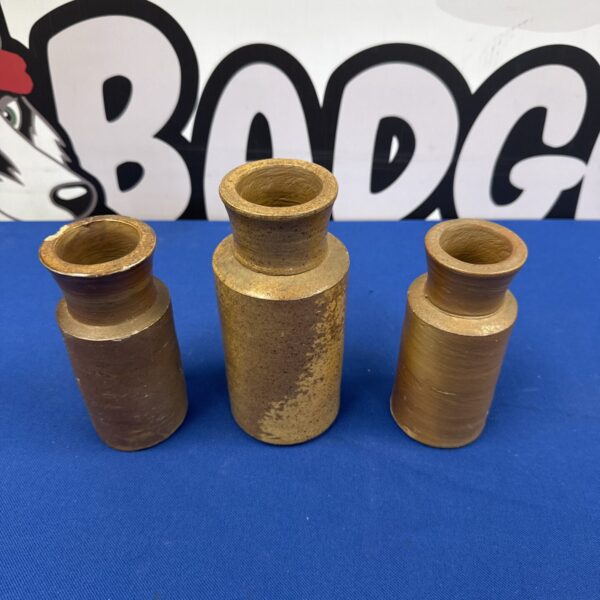 Three antique JBD blacking bottles with a dark background.