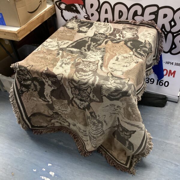 Vintage cat rug with repeating feline pattern for home decor.