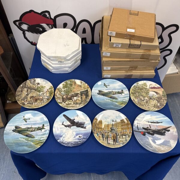 Collection of decorative aviation plates on a table.