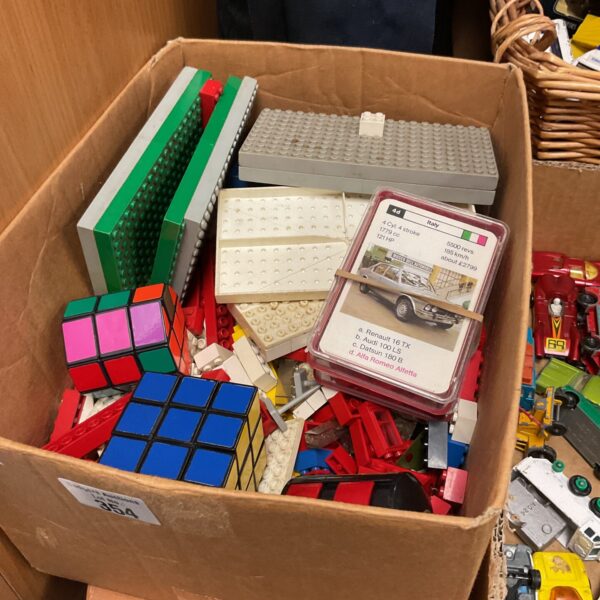 Overview of a vintage toy lot including Lego, Top Trumps and Rubik's Cube.