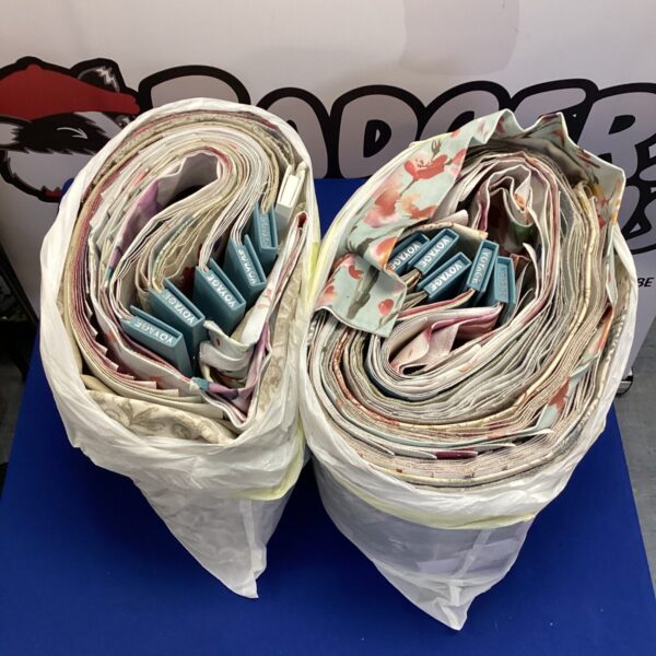 Two bags of Voyage upholstery fabric samples for interior design.