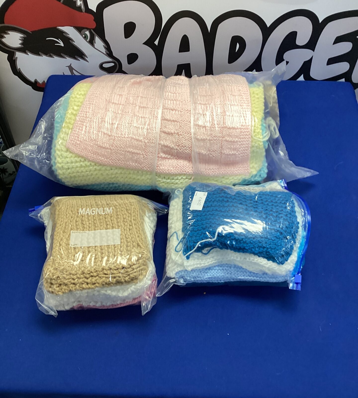 Two bags of knitted wool blankets