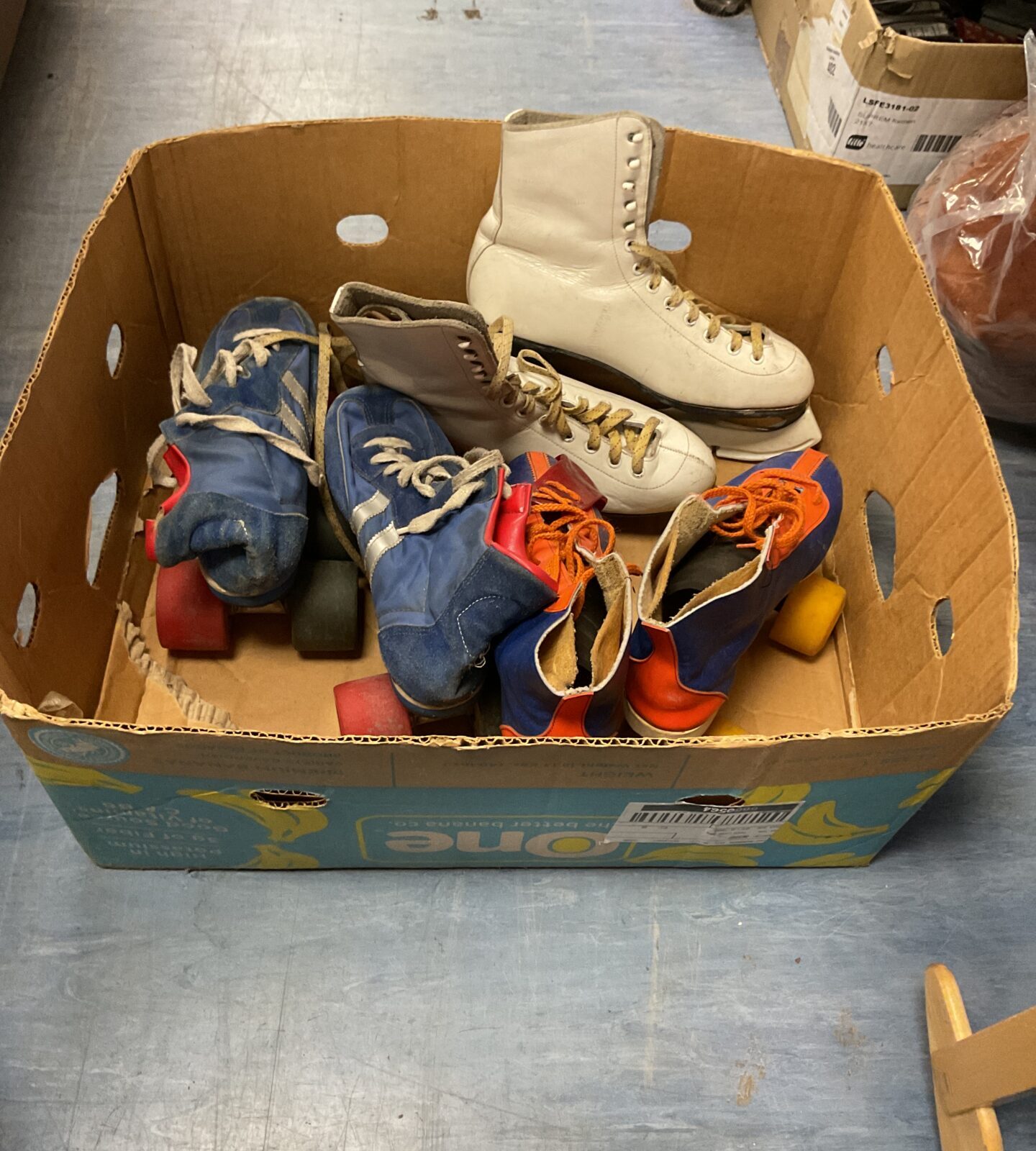 Box of vintage ice and roller skates
