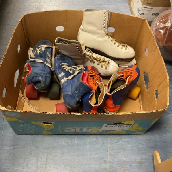 Box of vintage ice and roller skates