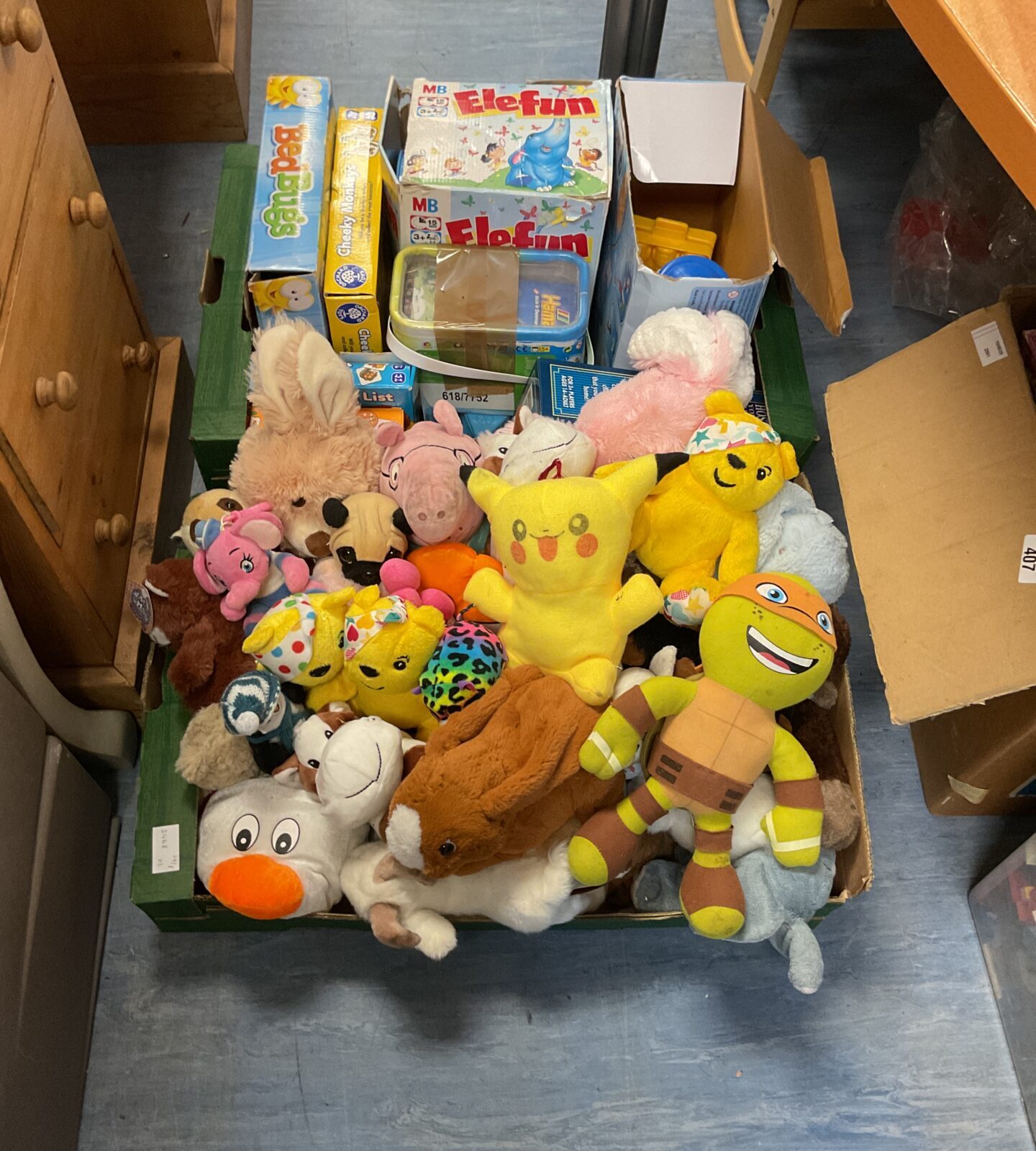 Two crates of mixed soft toys and games inc pugsy bear and pikachu