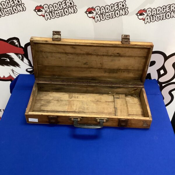 Front view of a vintage wooden tool box.